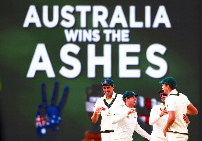 Australia's captain Steve Smith celebrates with teammates after winning the third Ashes cricket Test match at the WACA in Perth on Monday