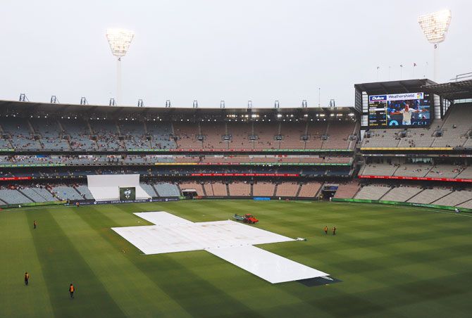 Covers laid on the pitch during a rain delay on Day 4 of the fourth Ashes cricket Test match
