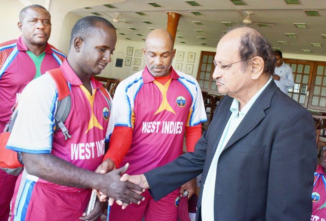 Former India captain Ajit Wadekar (right) greets West Indies' visually-impaired cricketers during the T20 World Cup for the blind at the Brabourne Stadium in Mumbai on Sunday