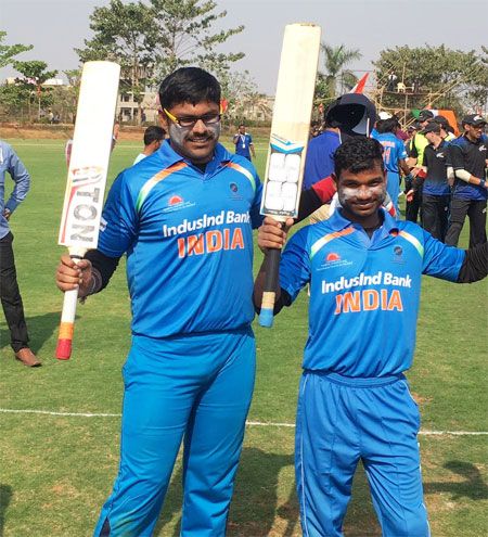 Players of India's blind cricket team celebrate on Tuesday