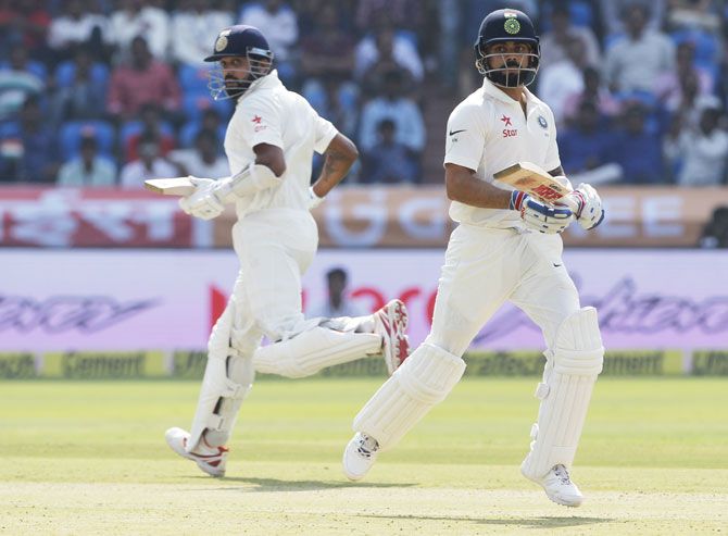 India's Virat Kohli and Murali Vijay jog between wickets on Day 1 of the one-off Test against Bangladesh in Hyderabad on Thursday