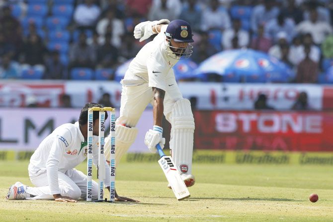 Mehdi Hasan (left) loses the ball as he attempts to run-out Murali Vijay