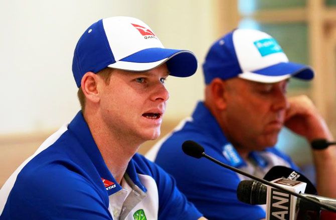 Australian cricket captain Steve Smith speaks as coach Darren Lehmann listens in at a news conference in Mumbai on Tuesday