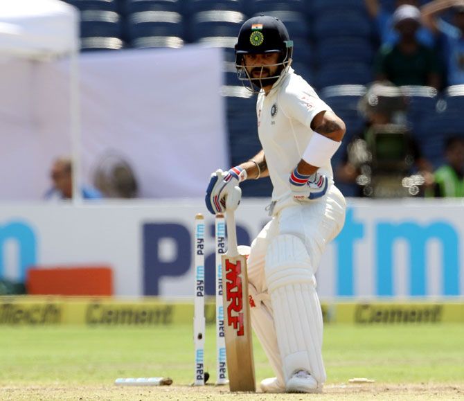  Virat Kohli looks on after he is bowled by Steve O'Keefe during the Pune Test match