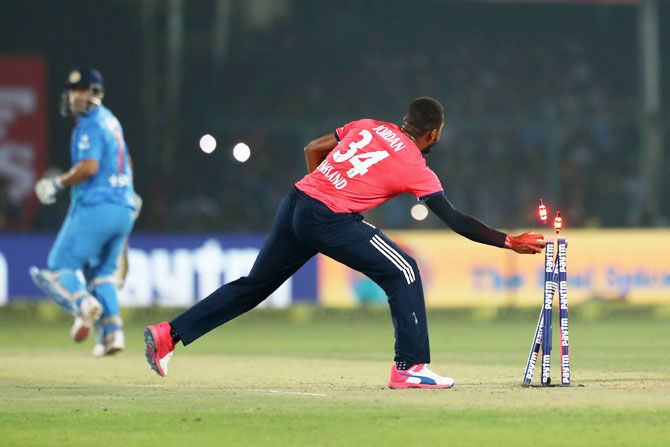  England's Chris Jordan breaks the wickets to run out India's Parvez Rasool during the first T20 International at Green Park Stadium in Kanpur on Thursday