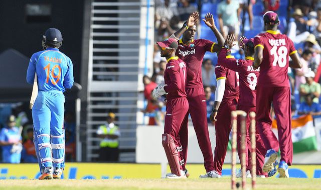 West Indies captain Jason Holder celebrates a wicket with teammates during the 4th ODI in North Sound, Antigua, on Sunday