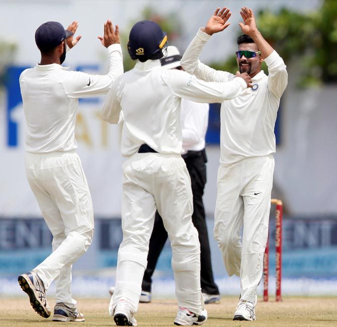 Ravindra Jadeja, right, celebrates with team mates after taking the wicket of Angelo Mathews