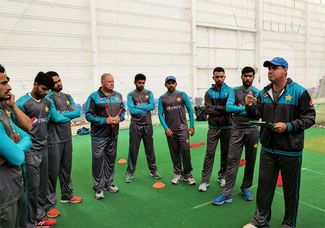 Pakistan coach Mickey Arthur speaks to his players during a training session