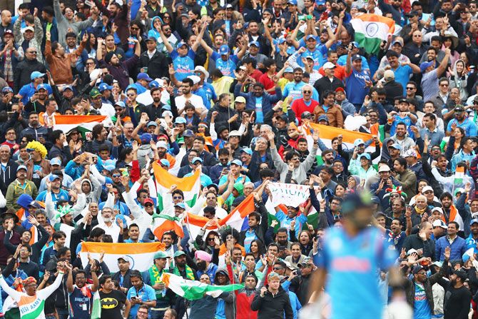 The India supporters cheer ballistic after a boundary comes off the bayt of Yuvraj Singh