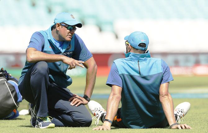 India coach Anil Kumble speaks with Yuvraj Singh during the nets
