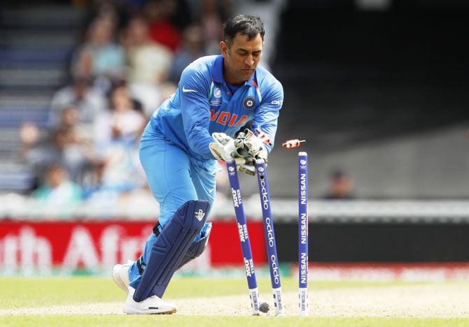 India's MS Dhoni breaks the stumps as South Africa's Imran Tahir is run out