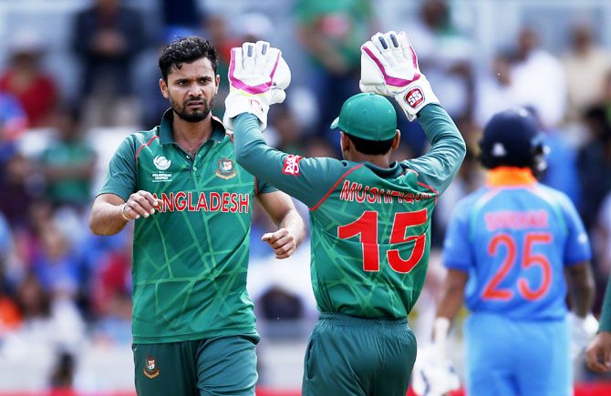 Bangladesh's Mashrafe Mortaza (left) celebrates the wicket of India's Shikhar Dhawan
