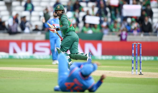Bangladesh's Tamim Iqbal watches as the ball races past India's Rohit Sharma