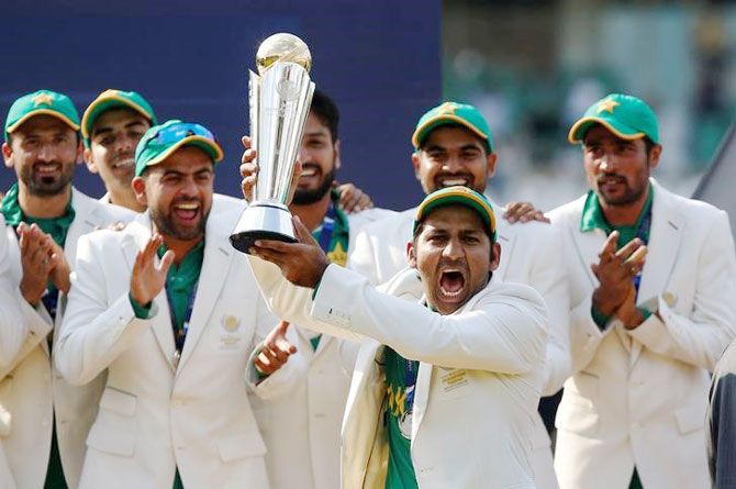Pakistan captain Sarfraz Ahmed holds aloft the Champions Trophy as he celebrates with his team after defeating India in the final on Sunday