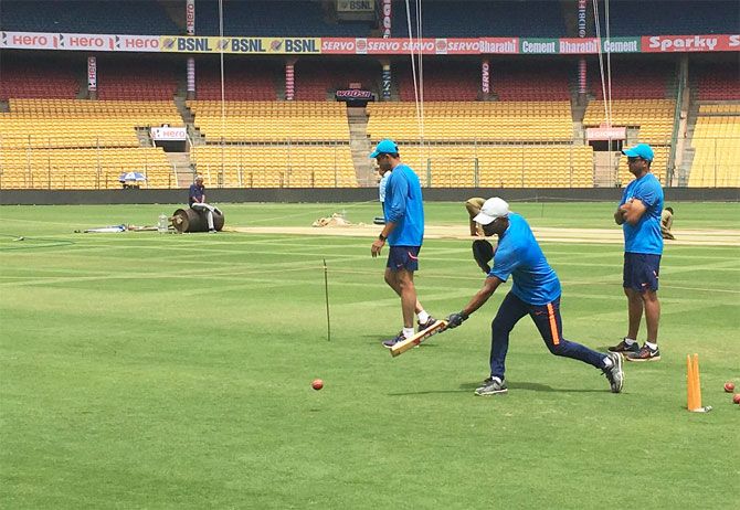 India's fielding coach R Sridhar gives the Indian players catching practice during training in Bengaluru on Thursday