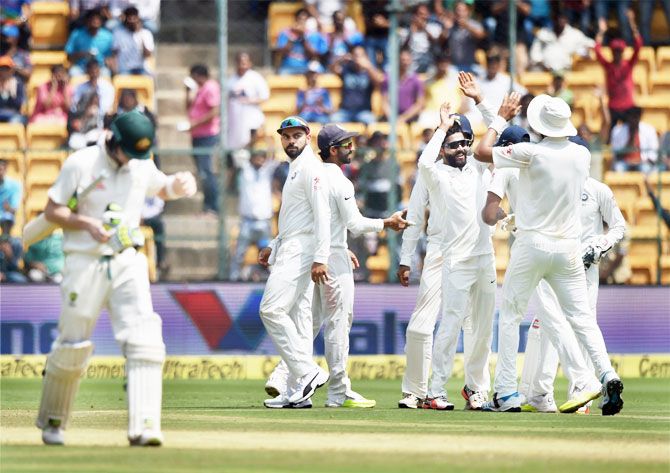 India's Ravindra Jadeja celebrate with team mates after claiming the wicket of Australia captain Steven Smith during the second day of the second Test match at Chinnaswamy Stadium in Bengaluru on Sunday