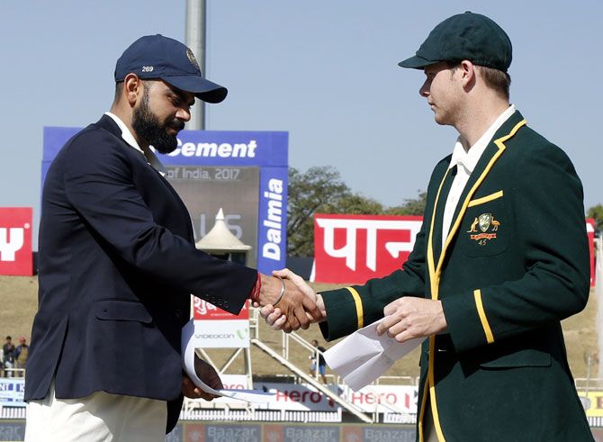 India captain Virat Kohli, left, shakes hands with Australia skipper Steve Smith at the toss