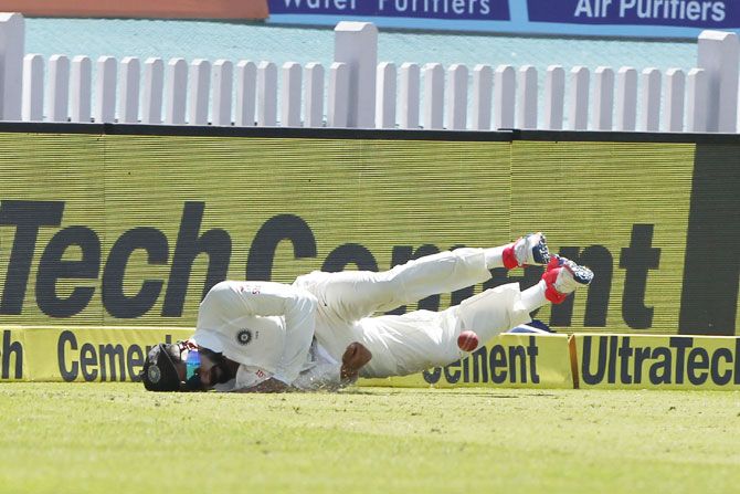India captain Virat Kohli falls on his shoulder while fielding during the 3rd Test against Australia in Ranchi on Thursday