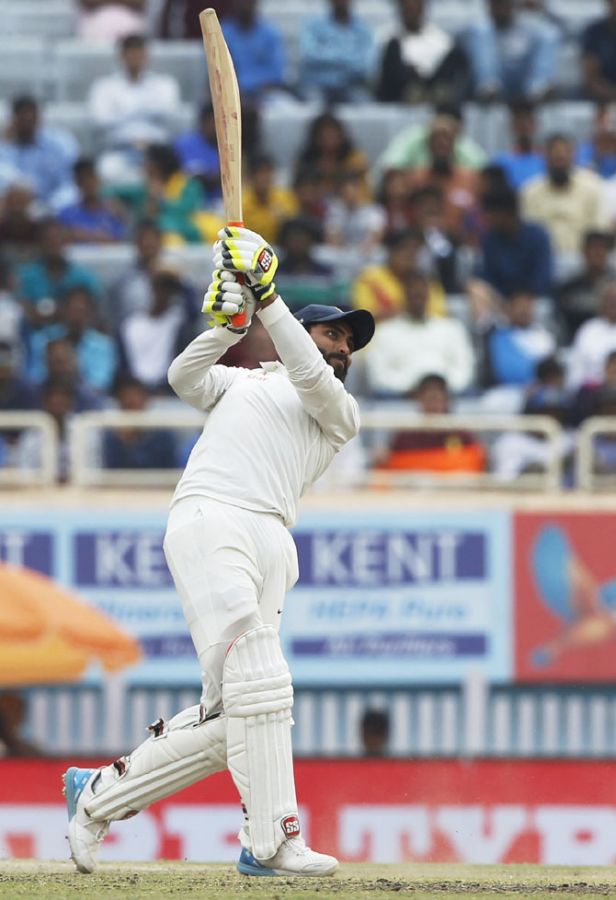 Ravindra Jadeja frees his arms as he sends a Nathan Lyon delivery for a six