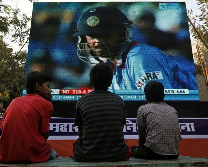 Children watch the 2011 ICC World Cup semi-final match between India and Pakistan on a big screen in Mumbai