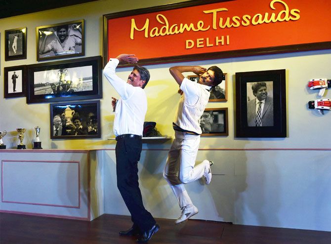 Former Indian Cricket Caption Kapil Dev poses with a wax figure of himself after unveiling the statue at Madame Tussauds Delhi, in New Delhi on Thursday