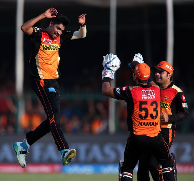 Mohammed Siraj, left, celebrates a wicket with his team mates