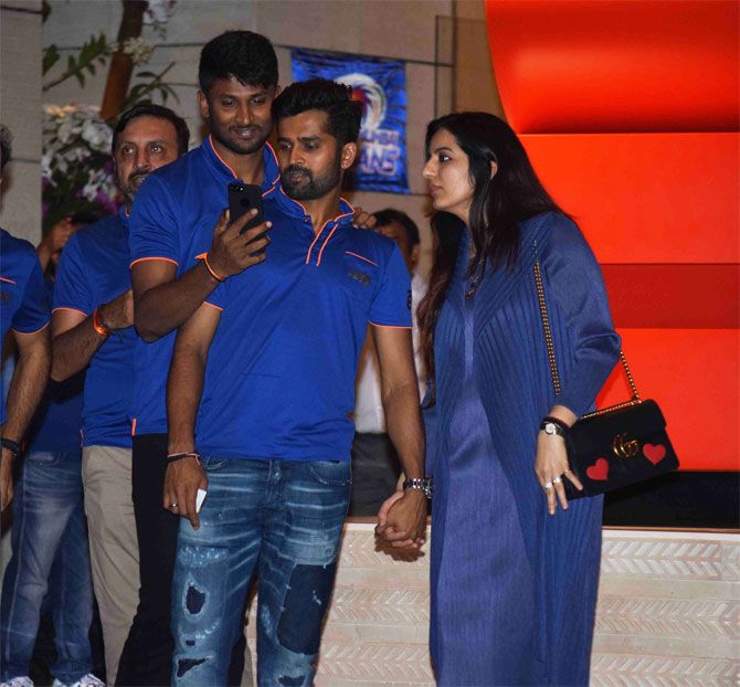 Mumbai Indians' R Vinay Kumar (right) arrives hand-in-hand with his partner