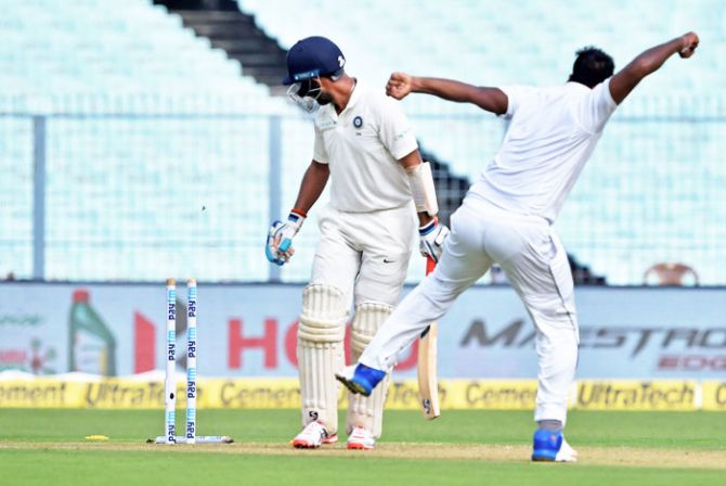 India's batsman Cheteshwar Pujara is bowled out by Sri Lankan bowler Lahiru Gamage on Day 3 of the first Test at Eden Gardens, in Kolkata on Saturday