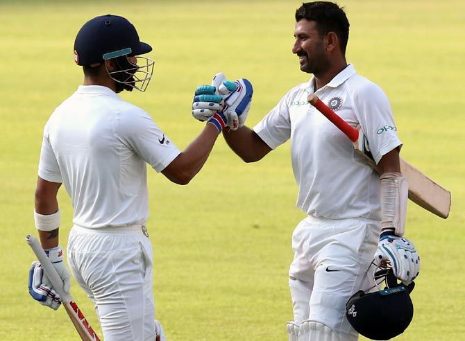 Virat Kohli, left, congratulates Cheteshwar Pujara on his century in the second Test against Sri Lanka in Nagpur