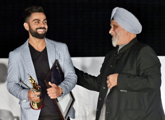 Legendary cricketer Bishan Singh Bedi felicitates Indian captain Virat Kohli at Delhi Captain Felicitation ceremony during the DDCAs 1st Annual Conclave 2017 at Ferozshah Kotla Stadium in New Delhi on Wednesday