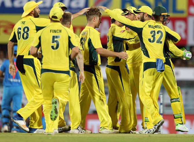 Australia's players celebrate after Adam Zampa dismisses Mahendra Singh Dhoni