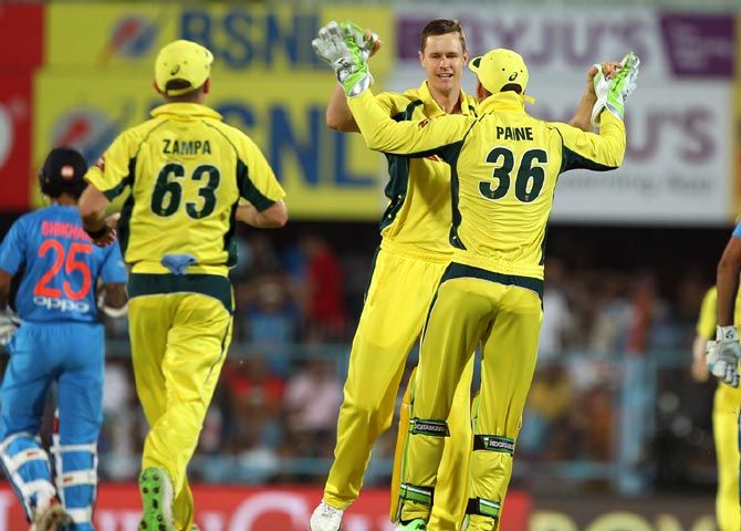 ason Behrendorff, centre, celebrates with team mates after taking the wicket of Rohit Sharma.