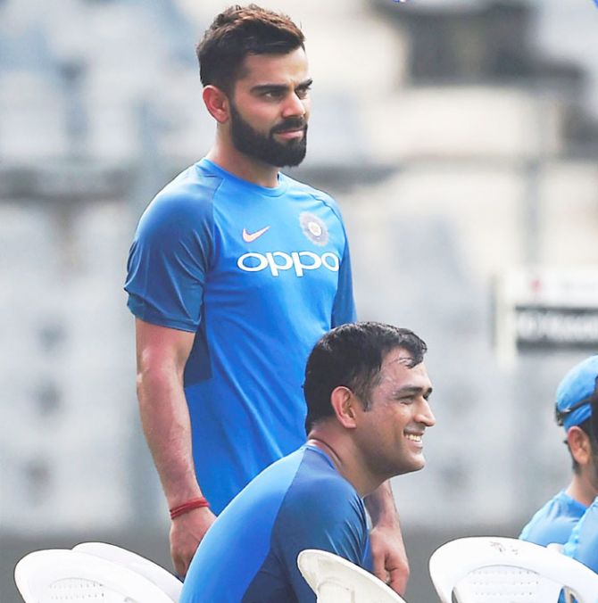 Virat Kohli and MS Dhoni before hitting the straps at a practice session