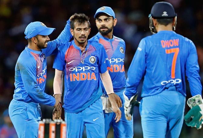 Yuzvendra Chahal celebrates a wicket with teammates. Kiwi coach Mike Hesson believes 'wrist spinners also provide scoring opportunities'