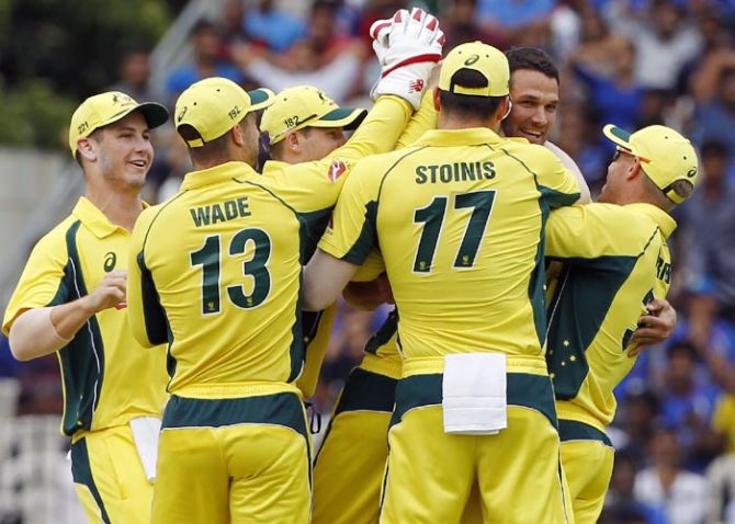 Australia's players celebrate with Nathan Coulter-Nile after taking the wicket of Virat Kohli