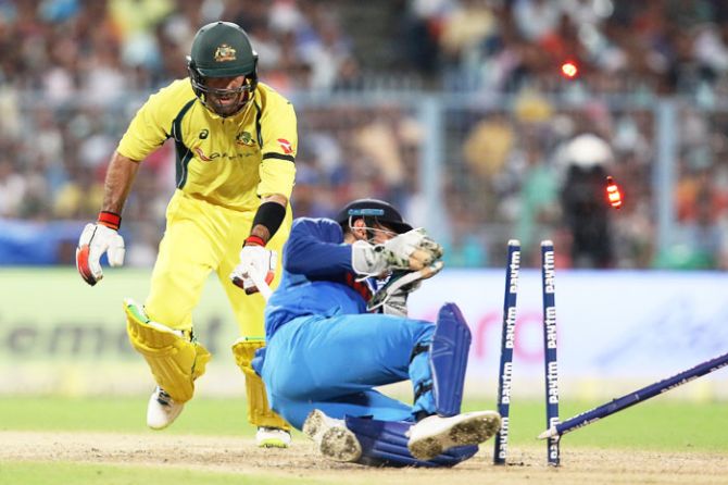 Mahendra Singh Dhoni removes the bails and uproots the stumps to have Glenn Maxwell run out
