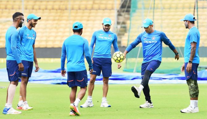 Mahendra Singh Dhoni and teammates enjoy a game of football during a practice session on Wednesday