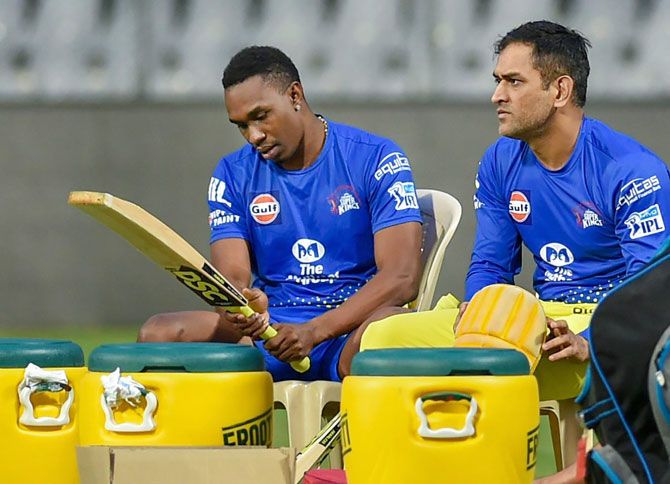 Chennai Super Kings' Dwayne Bravo and Mahendra Singh Dhoni relax during a practice session on Thursday
