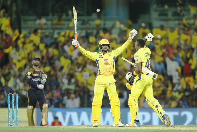 Ravindra Jadaja holds his arms aloft after striking the winning six