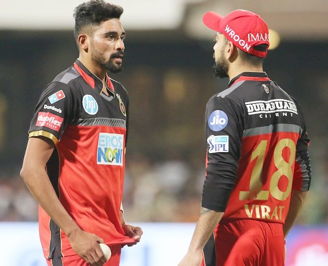 Virat Kohli has a chat with RCB pace bowler Mohammed Siraj. Chennai Super Kings chased down 206, and the RCB skipper lashed out at his bowlers' 'criminal' bowling, April 26, 2018. Photograph: BCCI