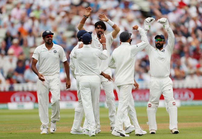 India's Ishant Sharma celebrates with teammates after taking the wicket of England's Ben Stokes