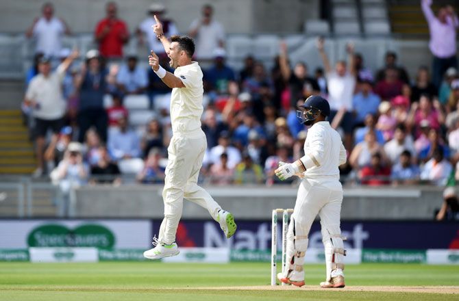 England's James Anderson celebrates dismissing India's Dinesh Karthik