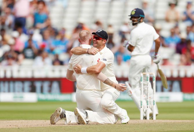 England's Ben Stokes and James Anderson celebrate the wicket of India's Virat Kohli on Day 4 of the first Test at Edgbaston in Birmingham on Saturday