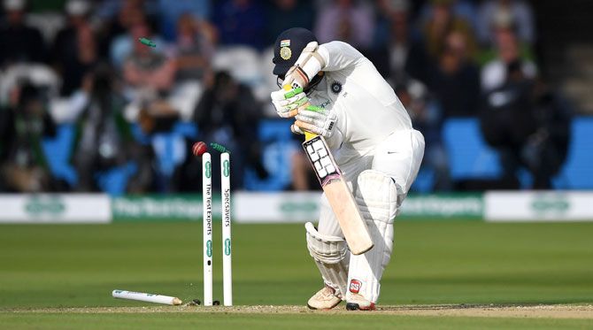 India's Dinesh Karthik is bowled by England's Sam Curran