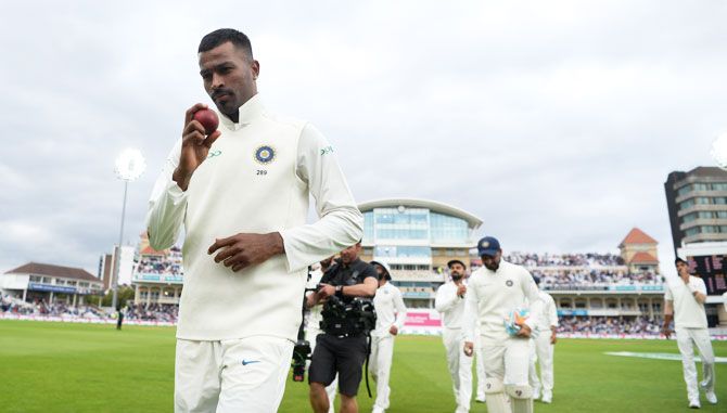 India's Hardik Pandya holds up the ball as his leads his team out after taking a five-wicket haul
