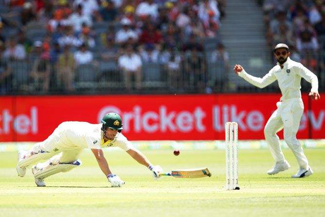 Australia's Aaron Finch dives to avoid a run-out