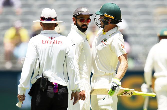 India's Virat Kohli and Tim Paine bump into each other