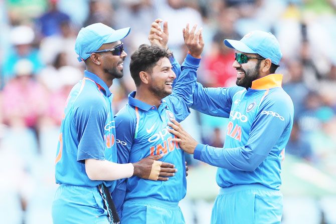 Kuldeep Yadav (centre) celebrates with teammates after picking the wicket of David Miller