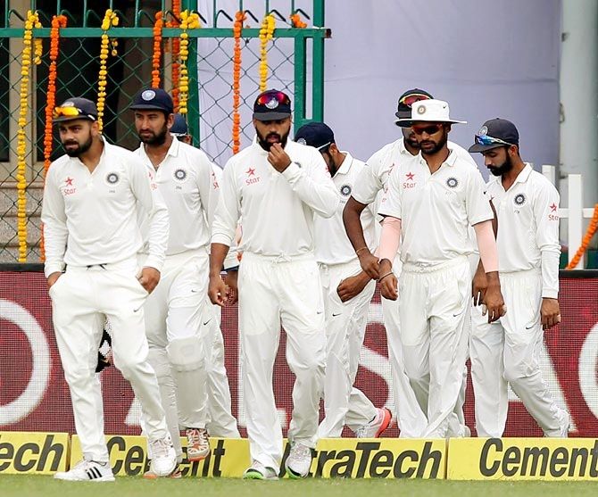 Virat Kohli leads the Indian team out to the middle
