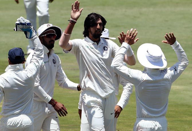Ishant Sharma, centre, celebrates with team mates after taking the wicket of Faf du Plessis